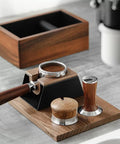 No Fuss 58mm Walnut Wood Espresso Tamper Station And Coffee Press Handle Holder Pro Barista Countertop Organizer displayed on a kitchen counter.