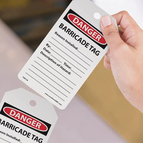 "Danger barricade tag in hand, Safety Tags by the Roll Caution Barricade OSHA Compliant Tags Waterproof PF Cardstock resists tears."