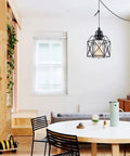 Sleek Matte Black Farmhouse Pendant Light Bringing Modern Industrial Vibe To Your Kitchen Island Or Dining Room Ceiling Hanging Fixture, suspended over dining table.