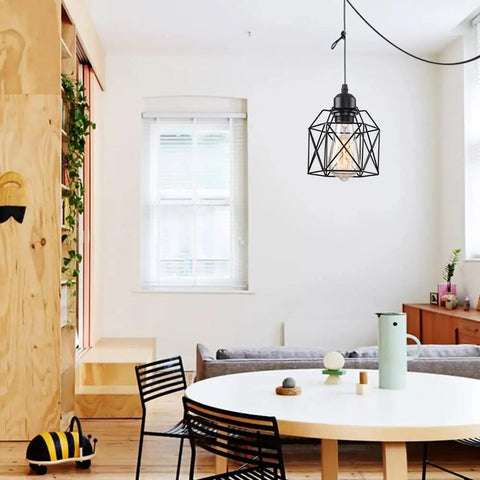 Sleek Matte Black Farmhouse Pendant Light Bringing Modern Industrial Vibe To Your Kitchen Island Or Dining Room Ceiling Hanging Fixture, suspended over dining table.