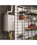 Mad Fast Instant Hot Water Flow Beige Natural Gas Tankless Water Heater mounted on a wall in a garage setting.