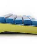 Kickass Sixty Percent Compact Mechanical Keyboard With Hot Swappable Top Tier Keys And Double Shot PBT Keycaps viewed from the side showing blue keycaps and sleek design.