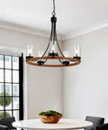Dining room with Five Light Wagon Wheel Farmhouse Chandelier Pendant Ceiling Light With Round Wood Finish, E12 Base, Clear Glass, Adjustable Chain, Dope Dining Room Or Living Room Vibe above table.