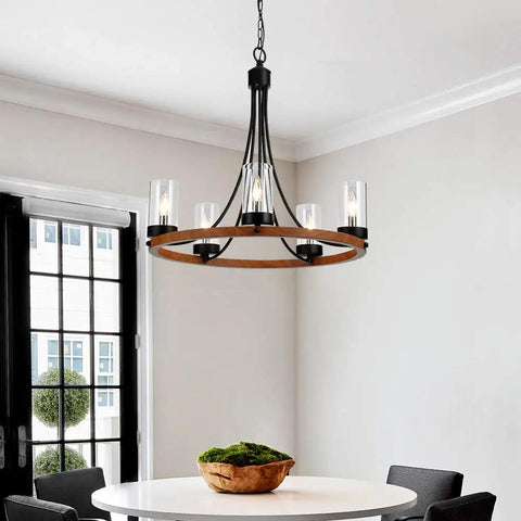 Dining room with Five Light Wagon Wheel Farmhouse Chandelier Pendant Ceiling Light With Round Wood Finish, E12 Base, Clear Glass, Adjustable Chain, Dope Dining Room Or Living Room Vibe above table.