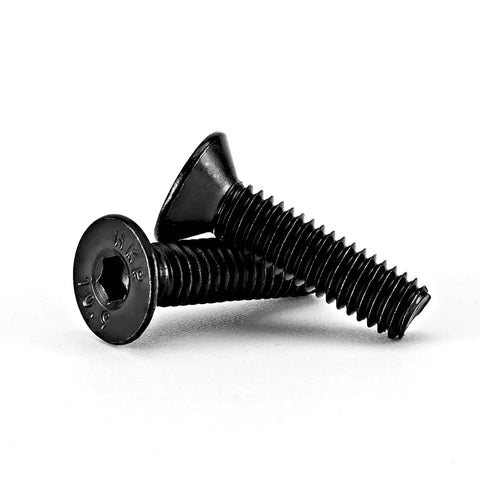Close-up of M4 0.7 X 10mm flat head hex socket cap screws, black oxide finish, alloy steel, shown at an angle.