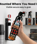 Hand holding Two Pack Portable Fire Extinguishers For Home Car Kitchen Garage And Campfires Dope Easy To Use Non Toxic And Ready To Go