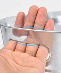 Close-up of hand holding Quad Pack Four Gallon Galvanized Ice Buckets With Heavy Duty Carry Handles For Beers Wines Cocktails And More Rust Proof Leak Proof Metal Cooler Tubs For Home Parties Bar Great For Beer Chillers And Wine Serving At Home Parties Or Bar Settings