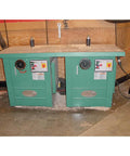 Straight Up 5 Hp Spindle Shaper With Three Quick Swap Arbors And Four Sick Speed Settings Built Tough For Heavy Duty Routing and Custom Woodworking Buildouts on a workshop table.