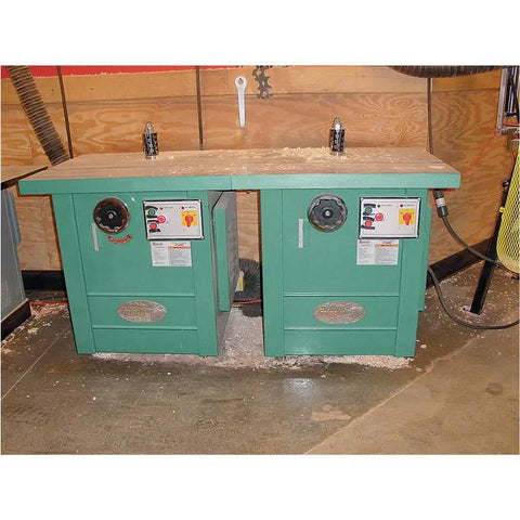 Straight Up 5 Hp Spindle Shaper With Three Quick Swap Arbors And Four Sick Speed Settings Built Tough For Heavy Duty Routing and Custom Woodworking Buildouts on a workshop table.