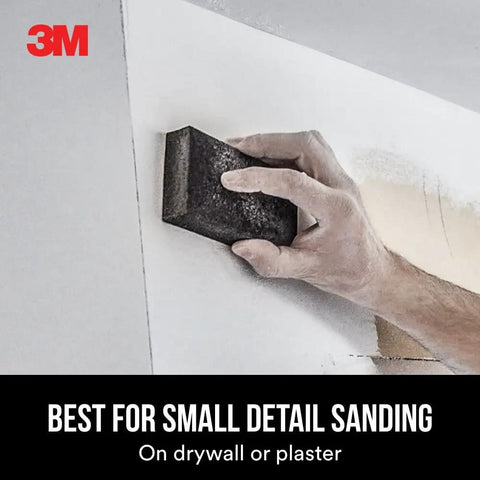 Hand using Dual Grit Drywall Sanding Sponge For Medium Remove And Fine Smooth Flexible Foam Block on wall