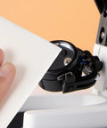 Hand holding a Top Shelf Lint Free Cleaning Wipe near equipment, demonstrating its use for cleanroom maintenance.