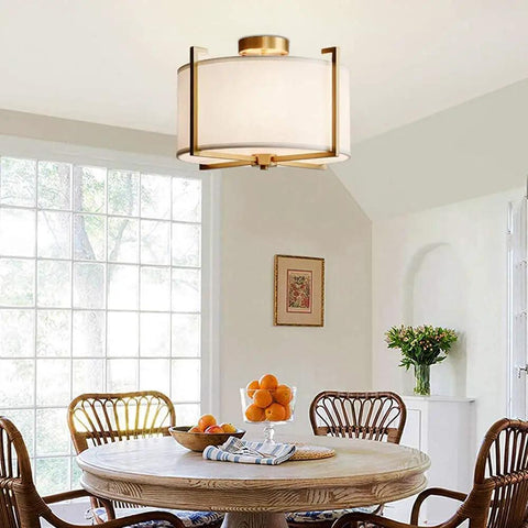Dope Brushed Brass Four Light Flush Mount Ceiling Light With Drum Fabric Diffuser over dining table, bright natural light