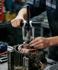 Person using Two Jaw Gear Puller 8 Inch Heavy Duty Claw Puller For Removal Of Pulleys Flywheels And Bearings in auto repair shop.