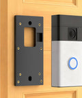 No Drill Doorbell Mount With Heavy Duty Adhesive Tape For Battery Powered Smart Video Doorbells installed on a door.