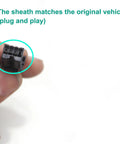 Close-up of black rectangular multi-pin motorcycle connector held between fingers