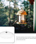 Weatherproof Outdoor Bird Feeder Cover Dome That Hangs As A Protection Shield displayed with bird feeder, forest background