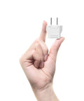 Hand holding small EU To US Travel Plug Adapter 220V To 110V Converter Type A 2 Pack For Europe To USA Canada Mexico.