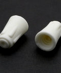Two white ceramic twist-cap wire connectors for 22-10 AWG electrical wires.