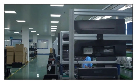 Industrial automation factory floor with storage shelves and worker, no specific product visible.
