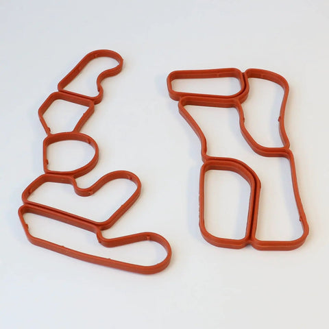 Engine Oil Filter Housing Gasket Set 2721840080 2721840280 For Mercedes Benz M272 Engines red rubber gaskets on white background