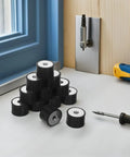 Beefed Up Rubber Vibration Isolator Mounts 12 Pack With M8 Double Threaded Design For Equipment And Generators, Easy Install, Superior Shock Absorption And Noise Reduction For Industrial And Manufacturing Use. Black rubber mounts on workbench
