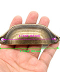 Vintage Seashell Shaped Cup Pulls Set In Antique Bronze Finish For Cabinets And Drawers, 8 Pack Iron Hardware held in hand.