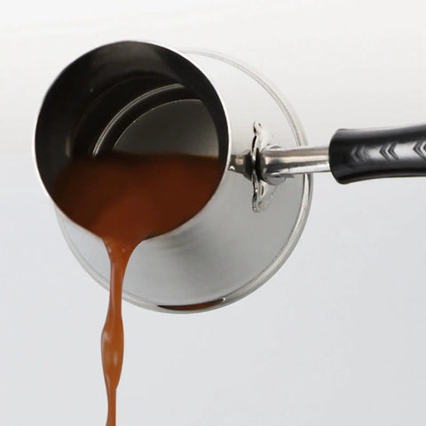 Stainless Turkish Coffee Pot pouring liquid, showcasing easy pour spout for stovetop brewing, durable 1mm grade steel design.