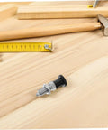 Heavy Duty Stainless Steel Spring Loaded Plunger Knob with Reset Indexing Mechanism on wooden workbench with tools.