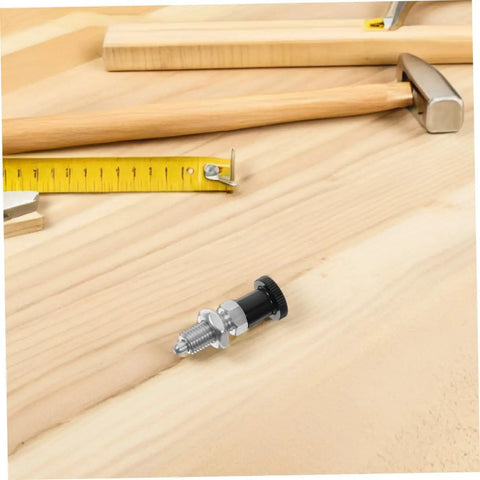 Heavy Duty Stainless Steel Spring Loaded Plunger Knob with Reset Indexing Mechanism on wooden workbench with tools.