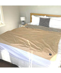 EMF Shielding Large Bed Blanket Made From Organic Cotton With Silver Lining displayed on a bed for sleep protection, 57 by 78 inches