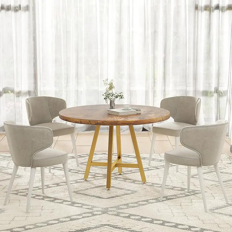 Gold X Shape Table Base For Glass Wood Marble Tops beneath a round wooden dining table with gray chairs, in bright room.