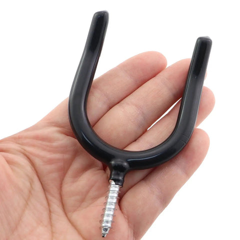 2 Pack Black Wall Mounted U Shaped Hooks For Garage And Warehouse Storage, Heavy Duty Metal Construction With Plastic Covered Surface, Each Hook Supports Up To 20 Pounds, Perfect For Shovels Rakes Hats And Garden Tools. Black U-shaped wall hook with screw mount held in hand