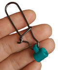 Close-up of 100 Pieces Fishing Line Sinker Slides With 8 Duo Lock Snaps, stainless steel, green, held in hand.