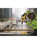 Worker using Heavy Duty Hammer Drill Dust Extraction System With Two Interchangeable Heads For Holes Up To One And A Half Inch And Two Inch, Rubber Seal For Masonry