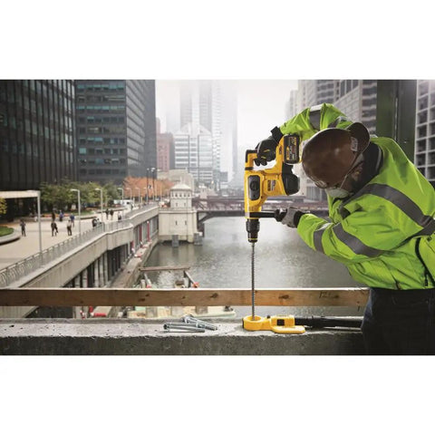 Worker using Heavy Duty Hammer Drill Dust Extraction System With Two Interchangeable Heads For Holes Up To One And A Half Inch And Two Inch, Rubber Seal For Masonry