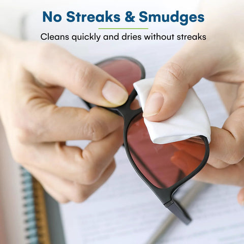 Care Touch eyeglass lens wipes used to clean black-framed sunglasses with red-tinted lenses; white wipe in hand