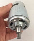 Badass 775 Brushed Micro Motor Replacement Part for Electric Wrench with 7 Tooth Gear shown in hand, metal construction, high torque.