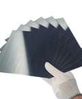 Hand holding Pro Grade Spring Steel Shim Set In 1095 Steel, Assorted Thicknesses 0.004, 0.008, 0.015, 0.02, 0.024, 0.03 in, 6x6 inch