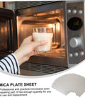 Hand placing glass of milk in microwave with Six Piece Microwave Mica Sheet Covers For Heat Shield And Insulation shown below