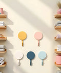 Set Of Ten Peel And Stick Wall Hooks Featuring Strong Adhesive Grip Easy Peasy Peel Backing For Bathroom Organization decorative pastel colors on a smooth wall.