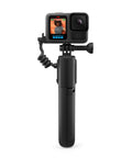 Volta Battery Grip for Action Cameras with GoPro attached, USB-C cable coiled, durable black build for outdoor shoots.