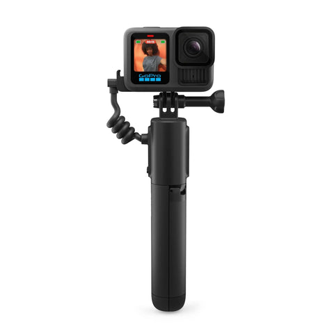Volta Battery Grip for Action Cameras with GoPro attached, USB-C cable coiled, durable black build for outdoor shoots.
