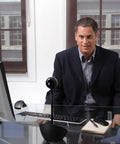 Man in a black suit using the All In One Desktop Video Conference Webcam With Carl Zeiss 1080p Hd Lens And Full Duplex Speakerphone.