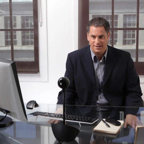 Man in a black suit using the All In One Desktop Video Conference Webcam With Carl Zeiss 1080p Hd Lens And Full Duplex Speakerphone.