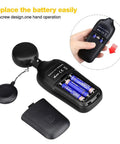 Digital Illuminance Meter Handheld Light Meter with open battery compartment, 3 AAA batteries, and user installing battery cover.