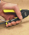 Hand using crimp tool from Coax Install And Test Kit With Crimp Tool, Tester, Stripper And Universal F Connectors for cable prep.