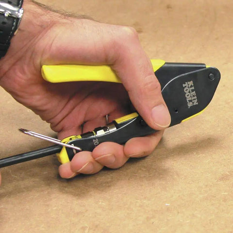 Hand using crimp tool from Coax Install And Test Kit With Crimp Tool, Tester, Stripper And Universal F Connectors for cable prep.