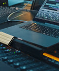 T7 Shield 1TB Portable External SSD Up To 1050 MB Per Second USB 3.2 Gen2 next to laptop in music production studio