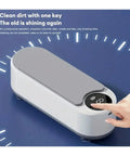 Portable Ultrasonic Cleaner With 360 Rotating Wash For Watches Jewelry And Dental Gear Compact Glovebox Friendly Build, showing a gray and white device.