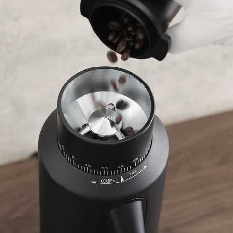 Dope Single Dose Electric Coffee Grinder Featuring 64Mm Titanium Flat Burrs And Stepless Adjustment To Nail Your Flavor Packed Espresso Routine In Sleek Black Finish with coffee beans pouring in.